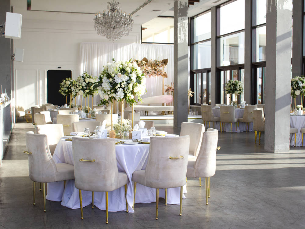 Elegant wedding setup in one of Saadiyat Beach Club’s event spaces, featuring floral décor and seating in Abu Dhabi.